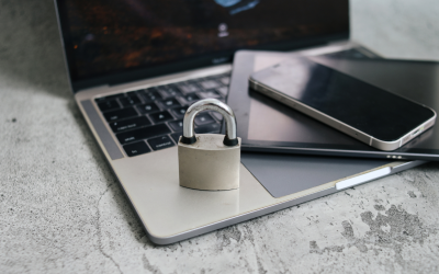 A lock sat on the corner of an open laptop with a phone